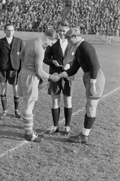 2 guys shaking hands before soccer game
